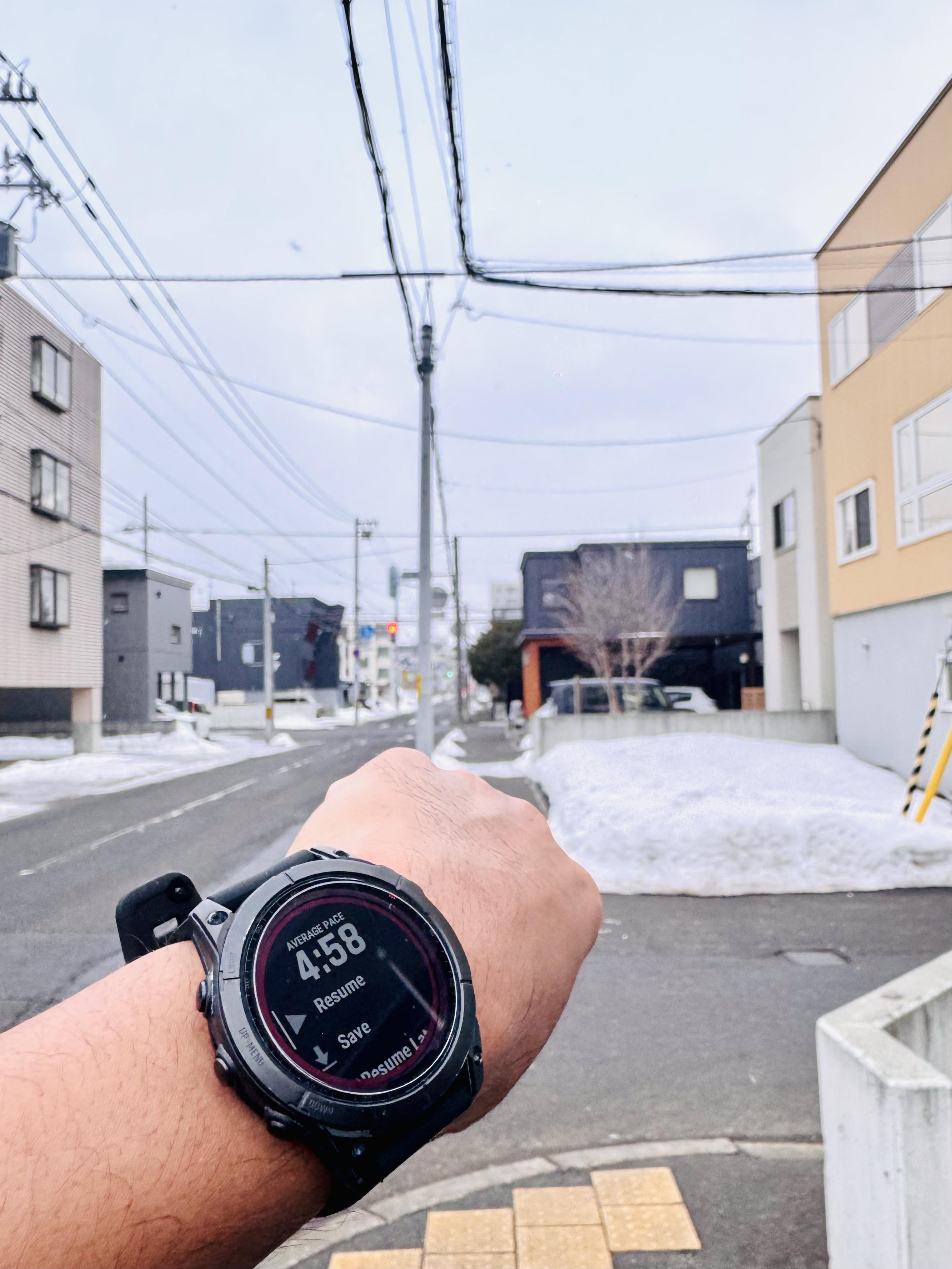 Checking pace on Garmin watch during snowy run
